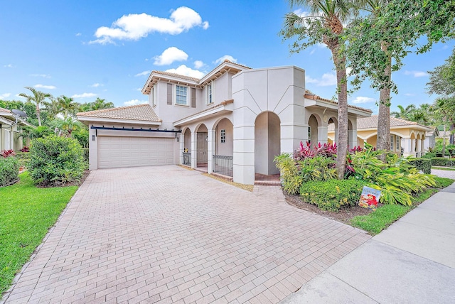 mediterranean / spanish-style home with a garage