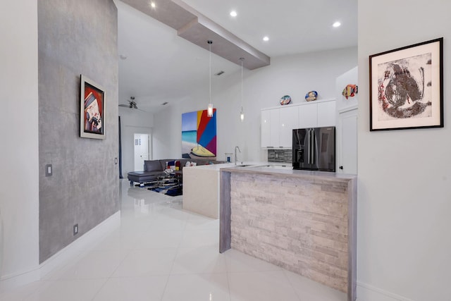 kitchen with ceiling fan, sink, refrigerator with ice dispenser, decorative light fixtures, and white cabinetry