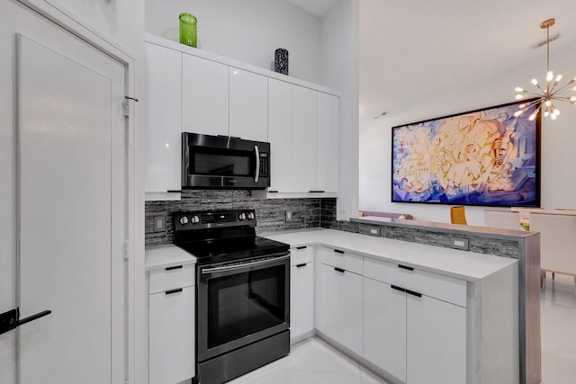 kitchen with appliances with stainless steel finishes, backsplash, an inviting chandelier, and white cabinetry