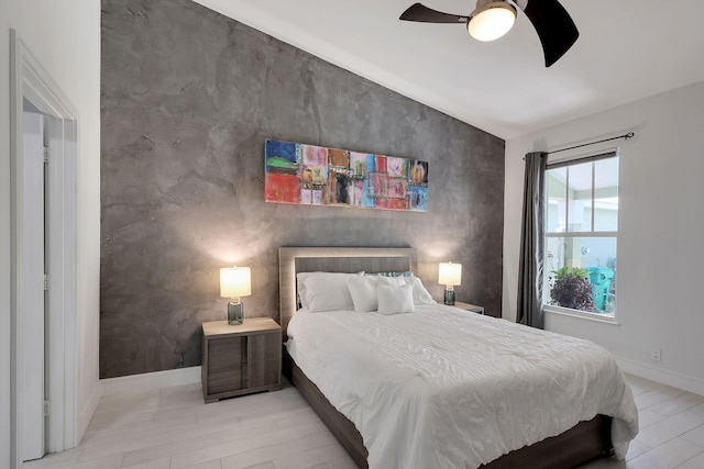 bedroom with ceiling fan and light hardwood / wood-style flooring