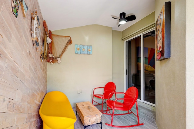 sitting room featuring ceiling fan, vaulted ceiling, and hardwood / wood-style flooring