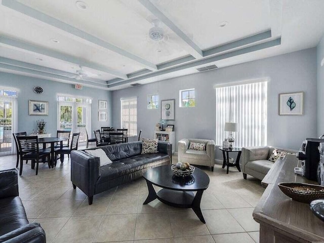 tiled living room featuring beamed ceiling, ceiling fan, a healthy amount of sunlight, and french doors