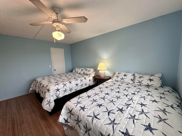 bedroom with wood-type flooring and ceiling fan