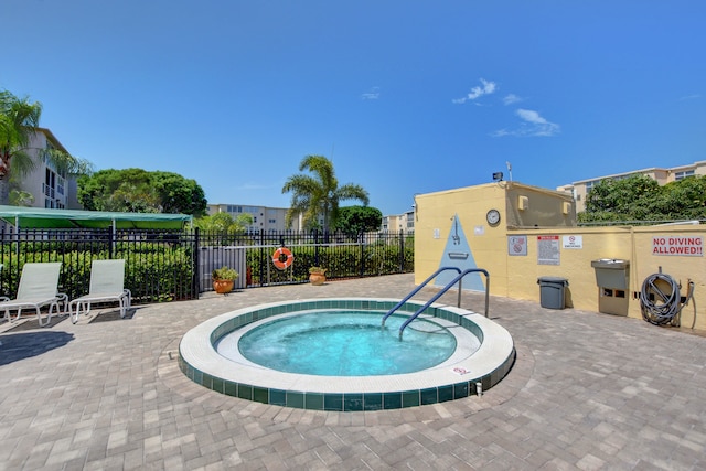 view of pool featuring a patio and a hot tub