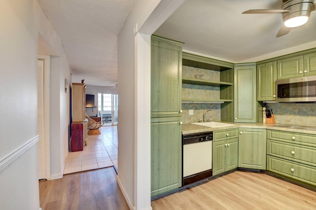 kitchen with ceiling fan, green cabinetry, light hardwood / wood-style flooring, dishwasher, and sink