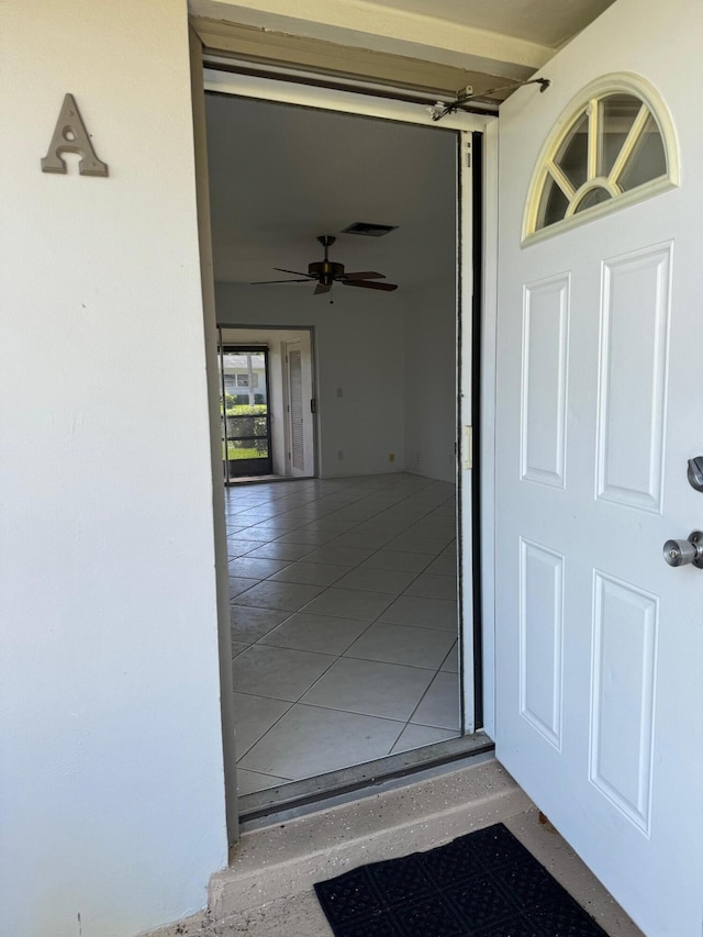 view of exterior entry featuring ceiling fan