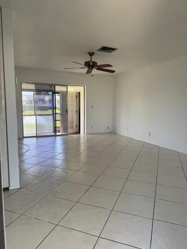 tiled empty room with ceiling fan