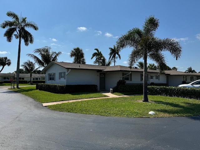 ranch-style home with a front lawn