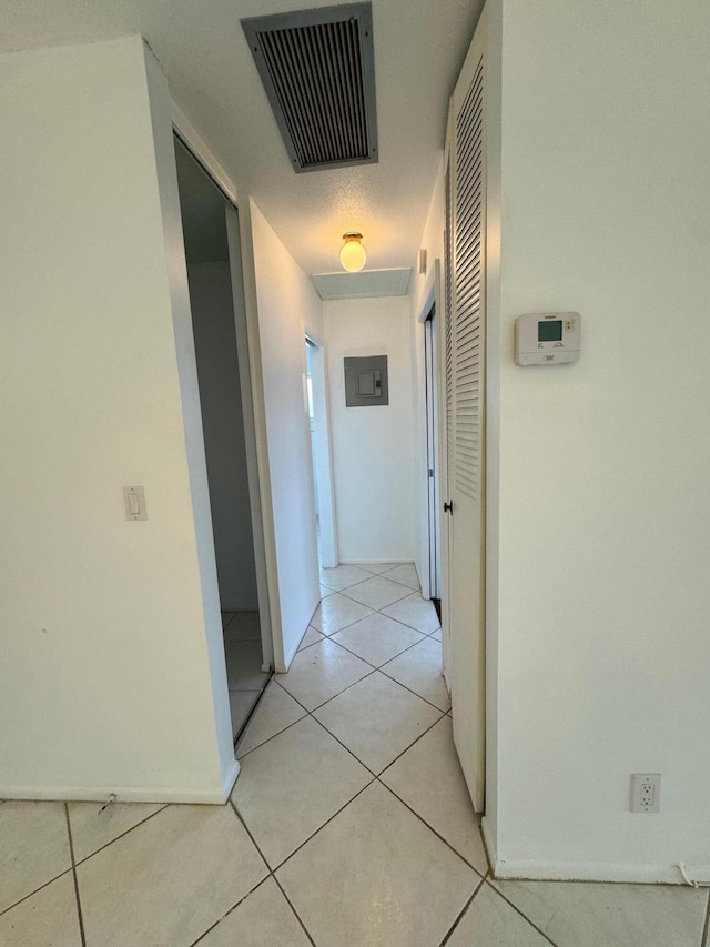 hall featuring light tile flooring