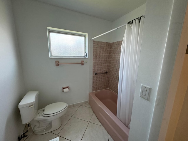 bathroom featuring tiled shower / bath, tile flooring, and toilet