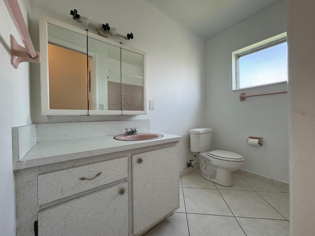 bathroom with toilet, tile floors, and large vanity