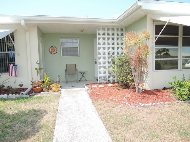 doorway to property featuring a yard