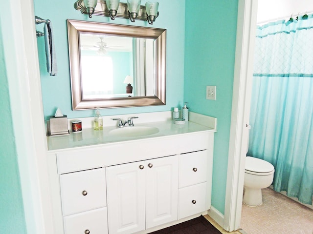 full bathroom featuring tile patterned floors, vanity, shower / tub combo, toilet, and ceiling fan