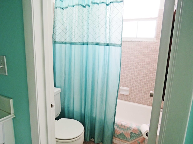 bathroom with toilet and shower / bathtub combination with curtain