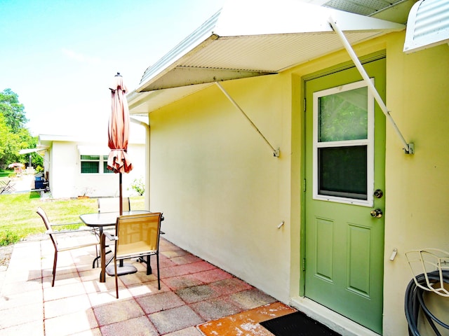 doorway to property with a patio area