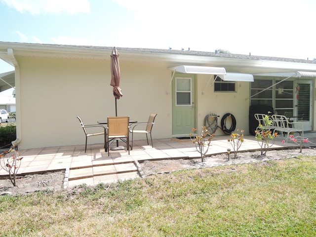 rear view of property with a patio area and a lawn