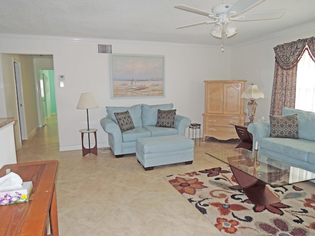 living room with ceiling fan, a textured ceiling, ornamental molding, and light tile patterned flooring