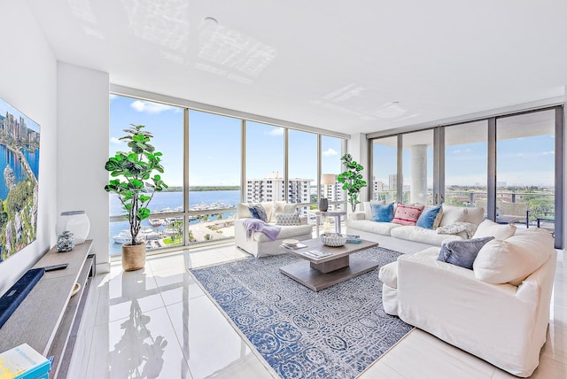 living room featuring a water view, expansive windows, and light tile floors