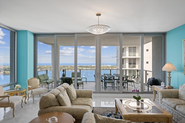 living room with a water view, floor to ceiling windows, and an inviting chandelier