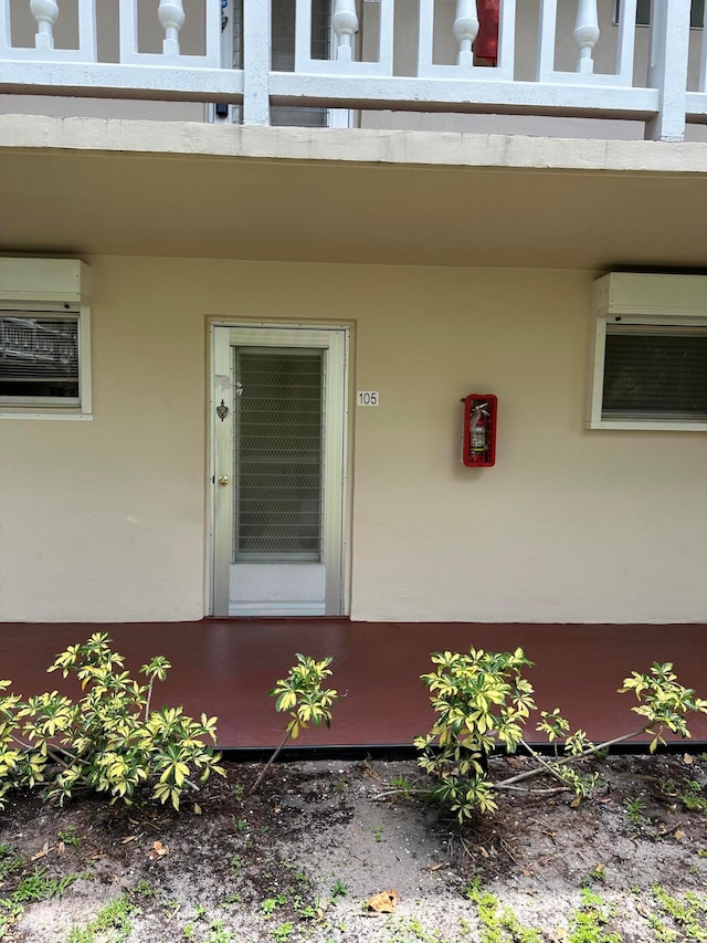 entrance to property featuring a wall unit AC