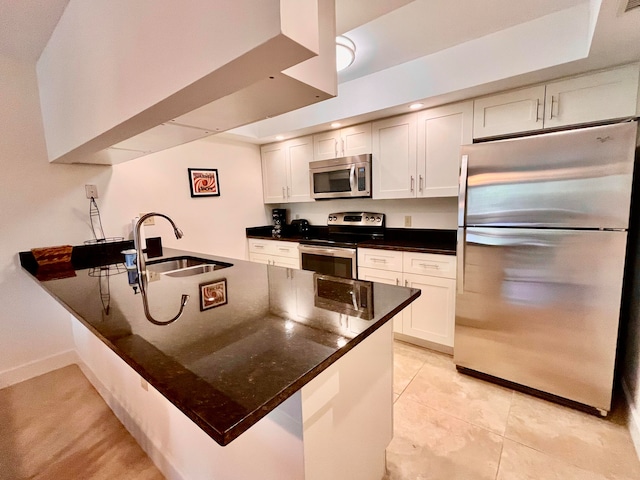 kitchen with appliances with stainless steel finishes, sink, white cabinets, and light tile flooring