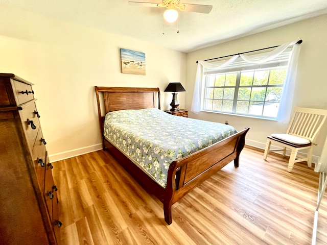 bedroom with ceiling fan and hardwood / wood-style flooring