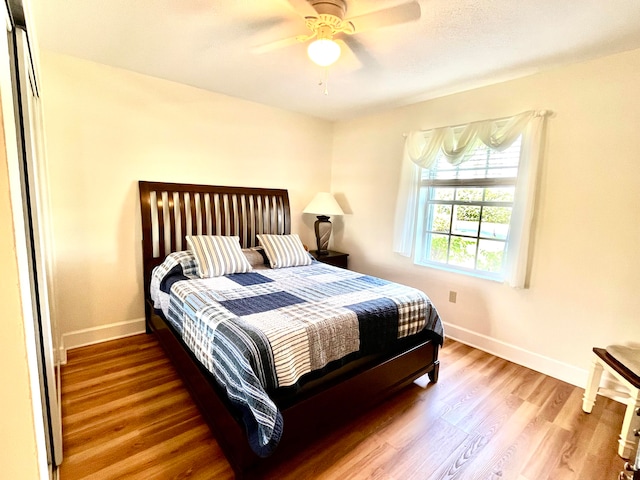 bedroom featuring ceiling fan and hardwood / wood-style flooring