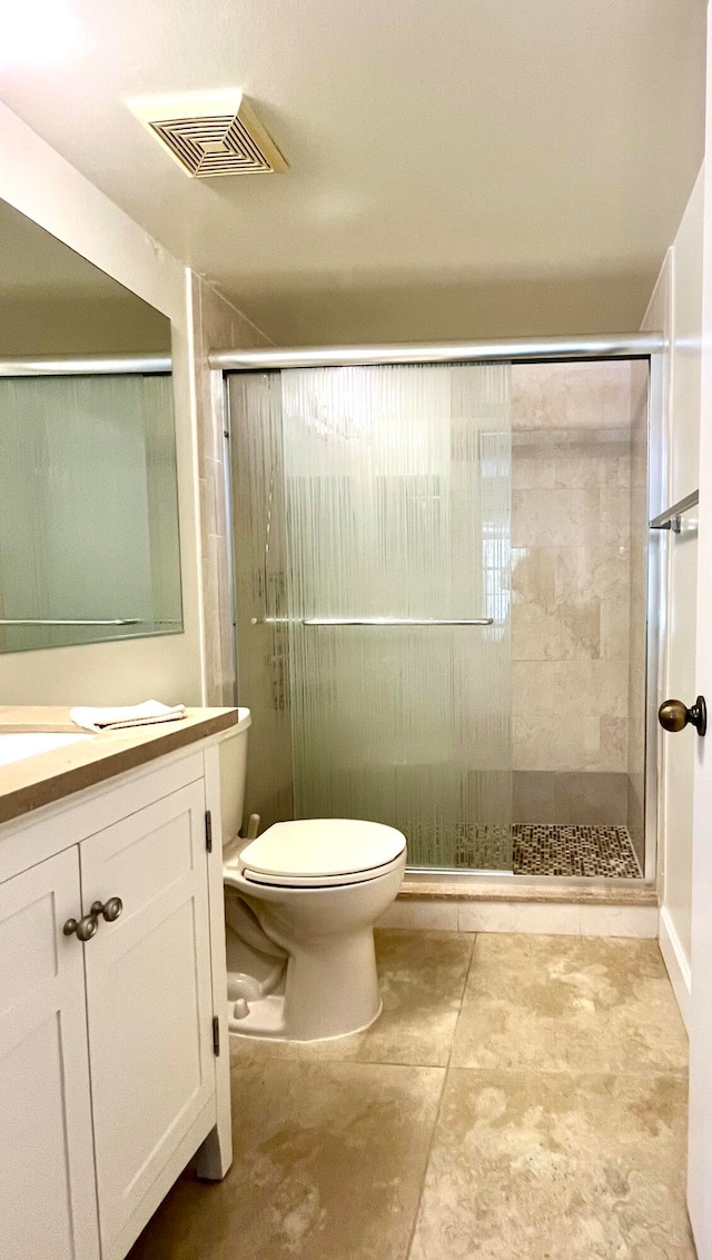 bathroom with an enclosed shower, oversized vanity, tile flooring, and toilet