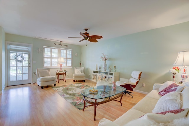 living room with light hardwood / wood-style floors and ceiling fan