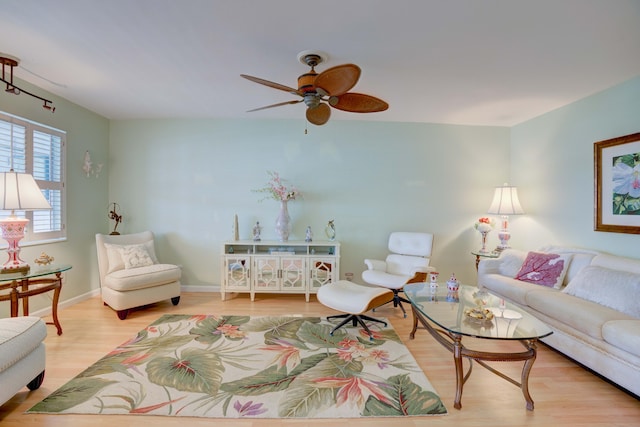 living room with ceiling fan and light hardwood / wood-style floors