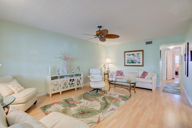 living room with light wood-type flooring and ceiling fan