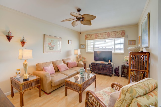 living room with crown molding, ceiling fan, and light wood-type flooring