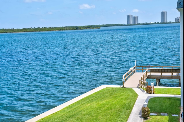 dock area featuring a water view and a lawn