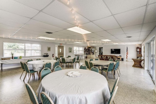 dining area featuring a drop ceiling