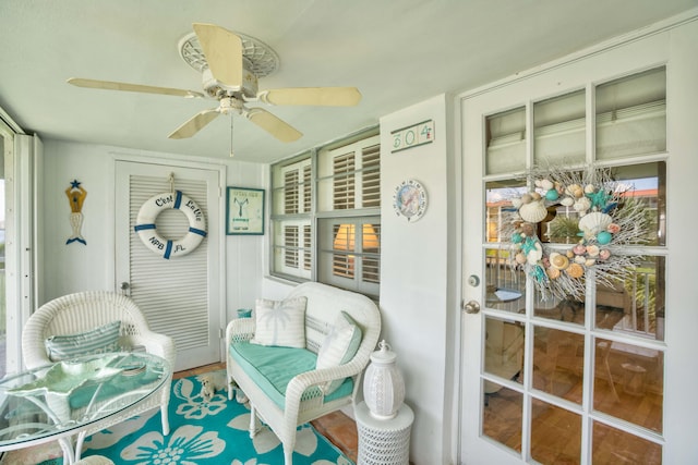 sunroom featuring ceiling fan