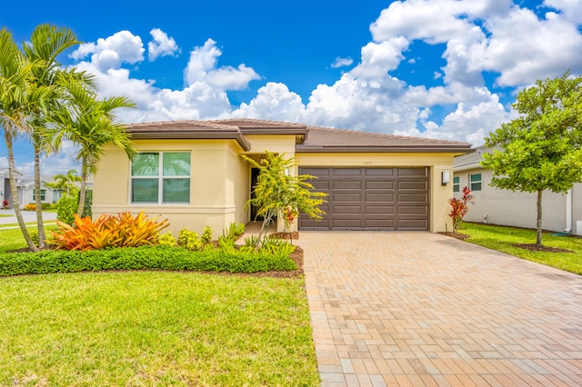 view of front facade with a front yard and a garage