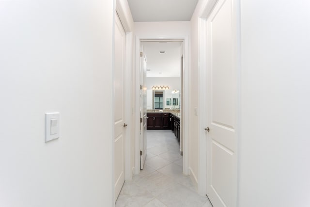 corridor featuring light tile patterned floors