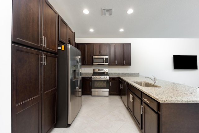 kitchen with dark brown cabinets, sink, kitchen peninsula, and stainless steel appliances