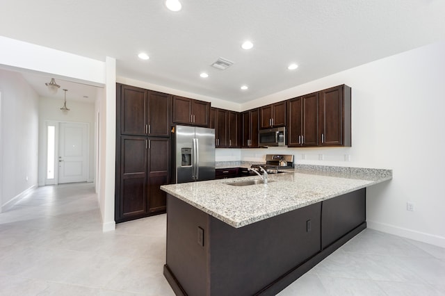 kitchen with pendant lighting, kitchen peninsula, sink, appliances with stainless steel finishes, and dark brown cabinetry