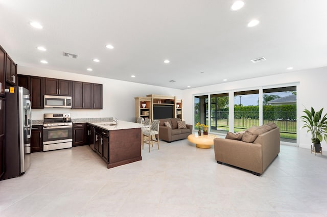 kitchen featuring dark brown cabinets, sink, and stainless steel appliances