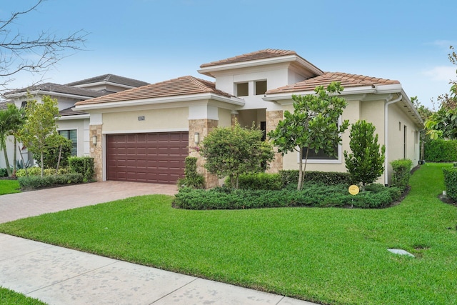 view of front of house featuring a front yard and a garage