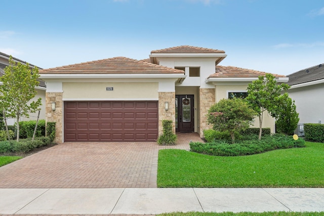 view of front of house featuring a garage and a front lawn