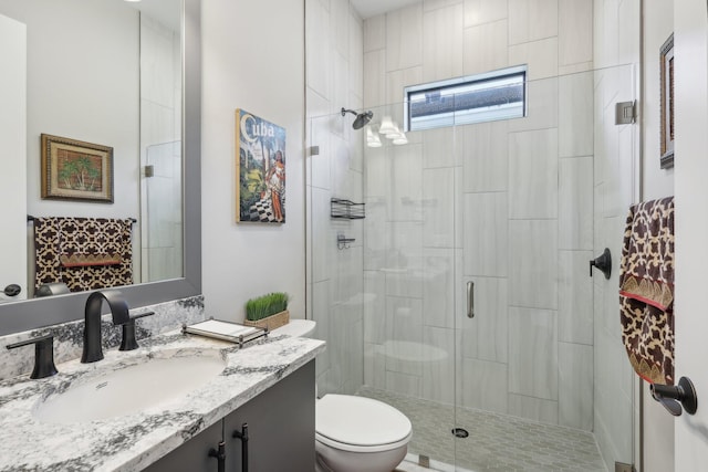 bathroom with vanity, toilet, and an enclosed shower