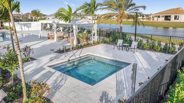 view of swimming pool with a patio, a water view, and a community hot tub