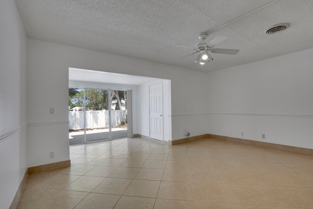 tiled spare room featuring ceiling fan and a textured ceiling