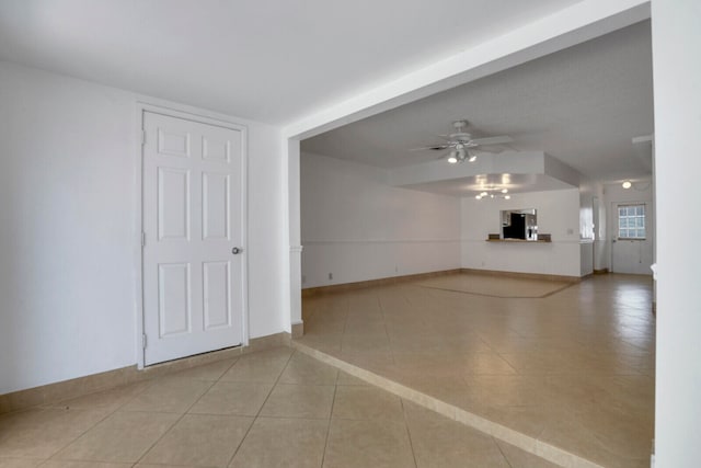 interior space with ceiling fan and tile floors