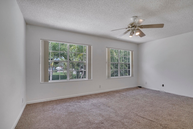 carpeted empty room featuring a textured ceiling and ceiling fan