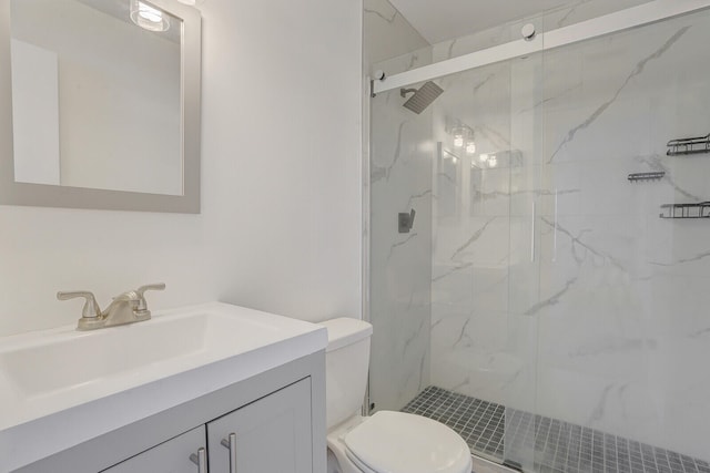 bathroom featuring an enclosed shower, toilet, and vanity