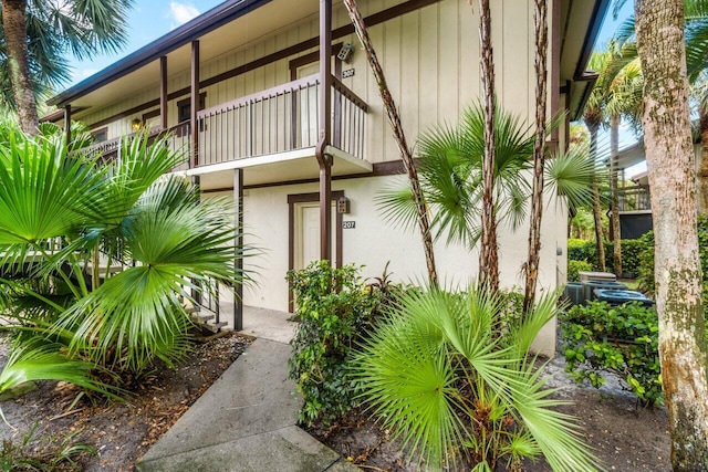 view of exterior entry featuring a balcony