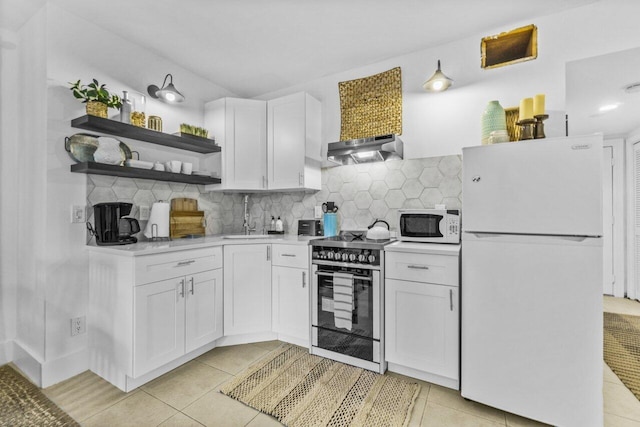 kitchen featuring white cabinets, light tile patterned floors, and white appliances